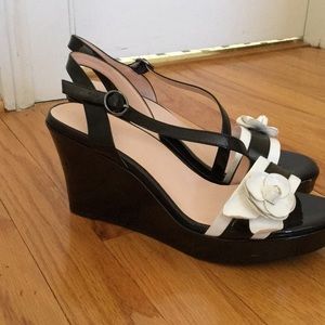 Black wedges with white flower on the front strap